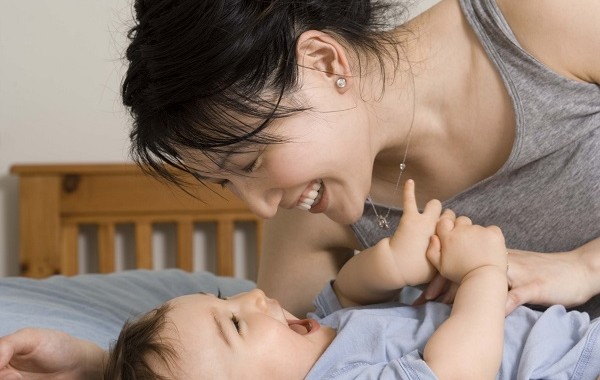 mom playing with baby