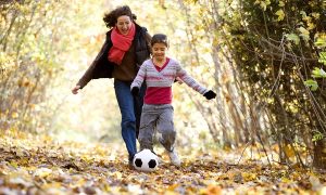 mom and child play soccer